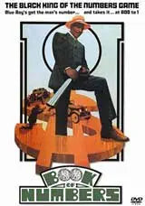 Man in suit sits atop a large number 4 in the Book of Numbers movie poster.
