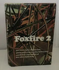 View of the Foxfire 2 book cover featuring Appalachian folklore, ghost stories, and rural skills, set against a background image of tangled branches.

