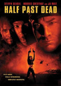 Movie poster for "Half Past Dead" features Steven Seagal, Morris Chestnut, and Ja Rule, as a woman raises guns near Alcatraz with a helicopter flying by.
