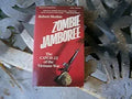 Robert Merkin's book, "Zombie Jamboree: The Catch-22 of the Vietnam War," features a rifle piercing a helmet on a red cover.
