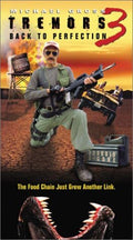 Michael Gross stars in Tremors 3: Back to Perfection, kneeling with a gun, ready to fight Graboids in Perfection, Nevada.
