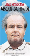 Jack Nicholson's face appears on the movie poster for "About Schmidt," set against a blue sky and white clouds.
