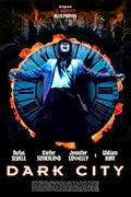 "The Dark City movie poster features a mysterious figure with arms outstretched against a flaming clock face backdrop, promoting the science fiction neo-noir film."
