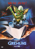 The Gremlins movie poster features a mischievous green Gremlin bursting through a box while holding a lit firecracker.
