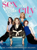 The Sex and the City cast poses for the Season Two DVD cover in front of a blurred cityscape.
