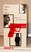 The Gun Shy movie poster features Liam Neeson, Oliver Platt, and Sandra Bullock, showcasing a red gun silhouette with a heart-shaped trigger.
