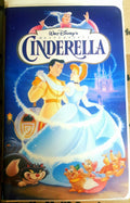 Vintage VHS cover shows Walt Disney's Cinderella dancing with Prince Charming as her fairy godmother, castle, and animal friends watch.
