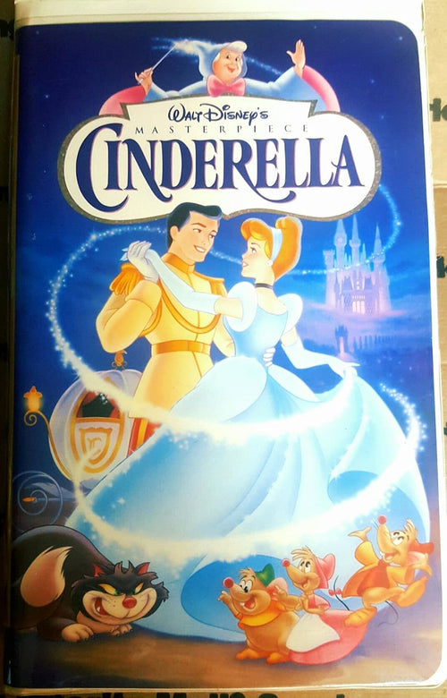 Vintage VHS cover shows Walt Disney's Cinderella dancing with Prince Charming as her fairy godmother, castle, and animal friends watch.
