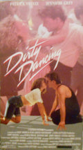 The Dirty Dancing movie poster features Patrick Swayze and Jennifer Grey performing a dance lift.
