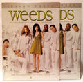 "Weeds" season three DVD cover features the cast in white clothing, promoting the comedy series about suburban drug dealing.

