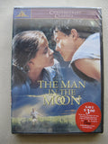 "The Man in the Moon" DVD cover features a young couple gazing intensely at each other above a girl running through a field.
