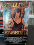 Sylvester Stallone stars as Rambo III on the digitally remastered VHS cover, featuring a helicopter, explosions, and horseback riders.
