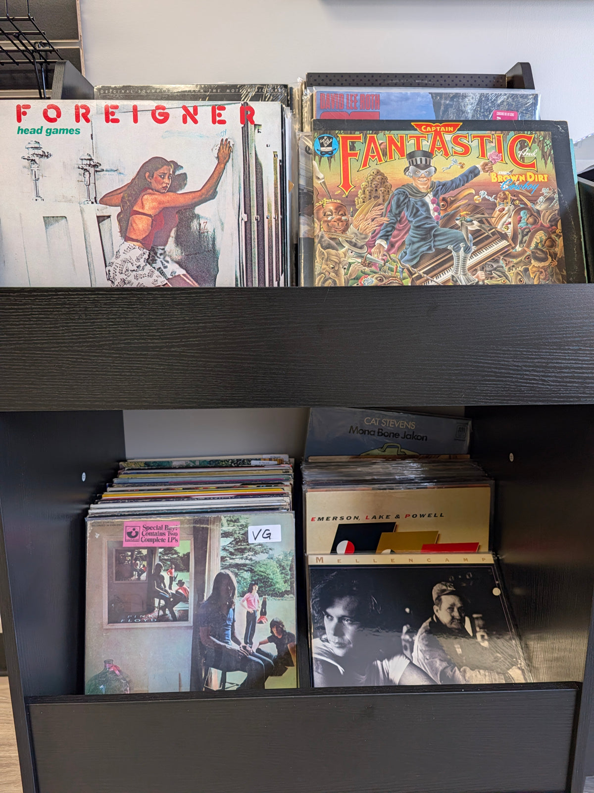 Vinyl sleeves arranged in a wooden record crate