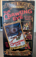 Showcases a "Shock Theatre" VHS tape for the horror movie "The Crawling Eye," featuring vintage artwork with a monstrous eye and terrified people.
