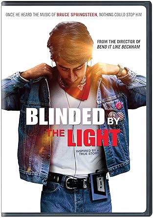 A young man in a denim jacket and bandana listens to Bruce Springsteen on a Walkman on the cover of the movie "Blinded by the Light."

