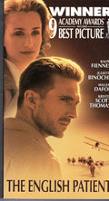 The English Patient movie poster features Ralph Fiennes and Juliette Binoche with an airplane and caravan crossing the desert.
