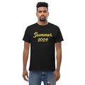 Man models a black Summer 2024 graphic tee and jeans.
