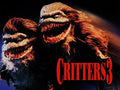 "Critters 3 movie poster features two furry alien creatures with menacing grins and sharp teeth."
