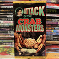 "Attack of the Crab Monsters" vintage movie cover shows giant crabs menacing a scientist, part of an Allied Artists Classics Library collection.
