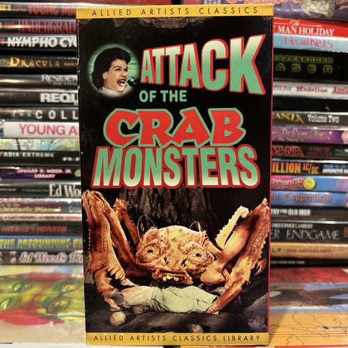 "Attack of the Crab Monsters" vintage movie cover shows giant crabs menacing a scientist, part of an Allied Artists Classics Library collection.
