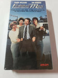 Robin Williams stars in "Cadillac Man" as a car salesman facing a crisis with a gunman, as depicted on the vintage VHS cover.
