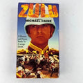 A vintage VHS tape of the movie "Zulu" featuring Michael Caine displays its cover art with a dramatic battle scene and Caine in uniform.
