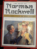 Norman Rockwell paints girls in nurses' outfits on canvas, as seen on "The Best of Norman Rockwell" book cover.
